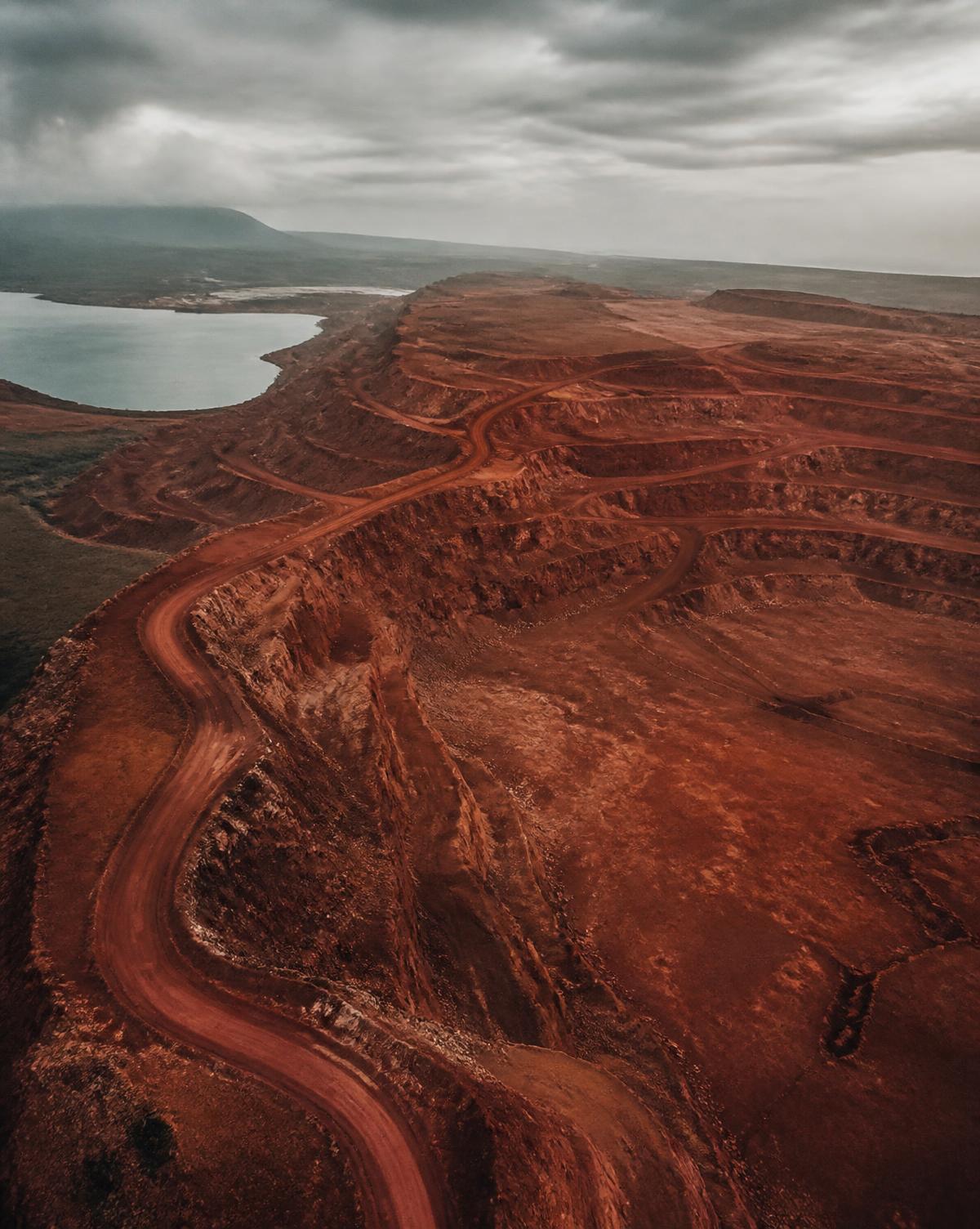 Reddish-brown bauxite-bearing terrain with exposed mineral benches