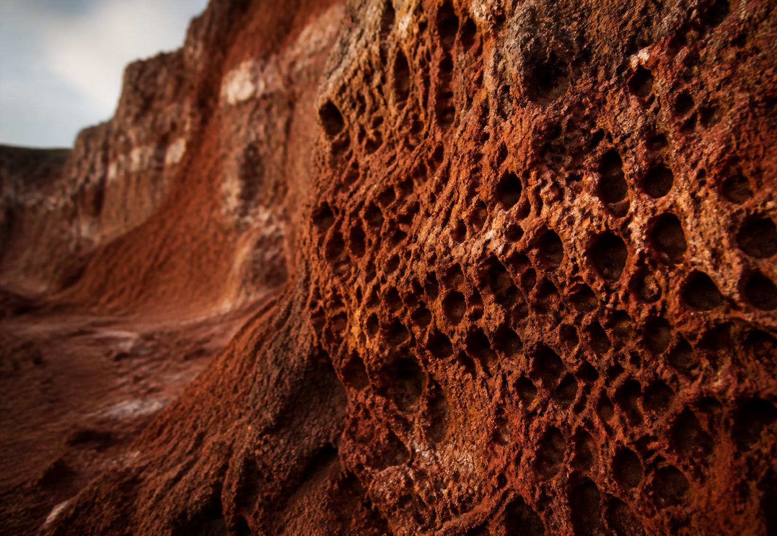 Weathered aluminous laterite rock face showing iron-rich texture
