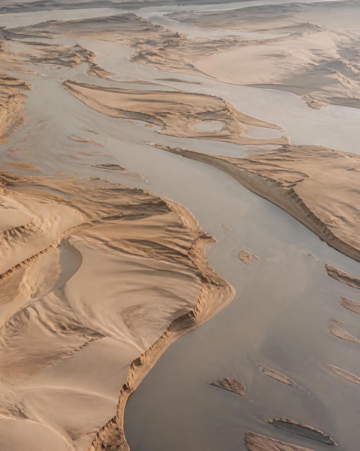 Aerial view of a wide river channel with pale sandbars in Bundelkhand